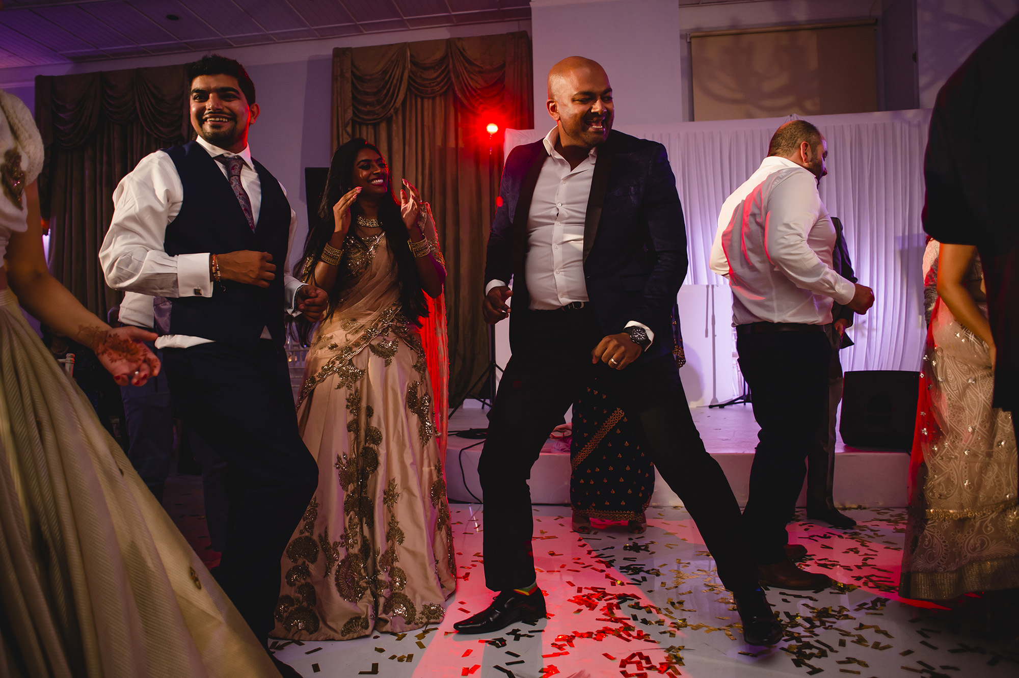 wedding guests dancing at reception	