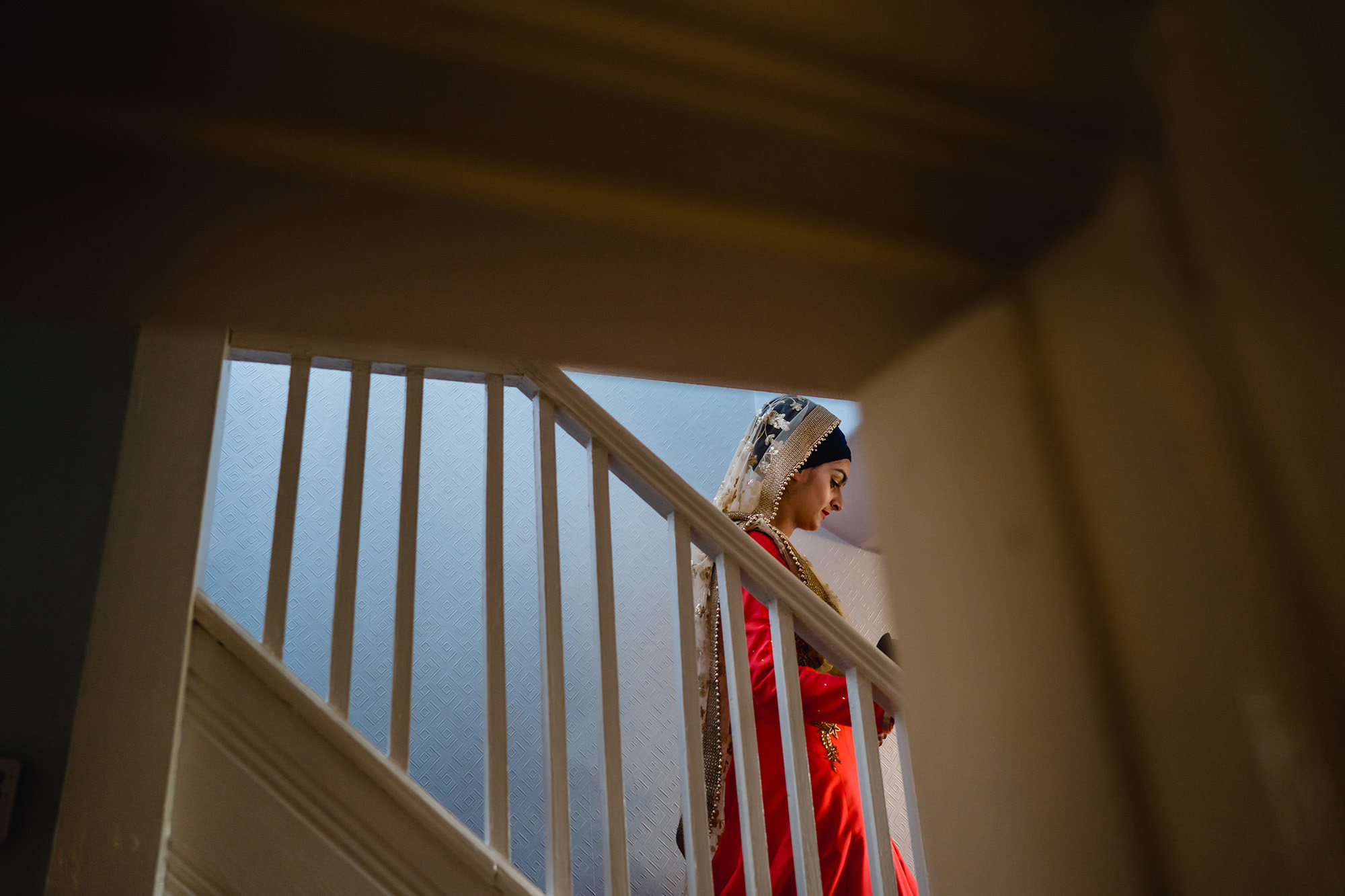 bride coming down the stairs for her doli ceremony