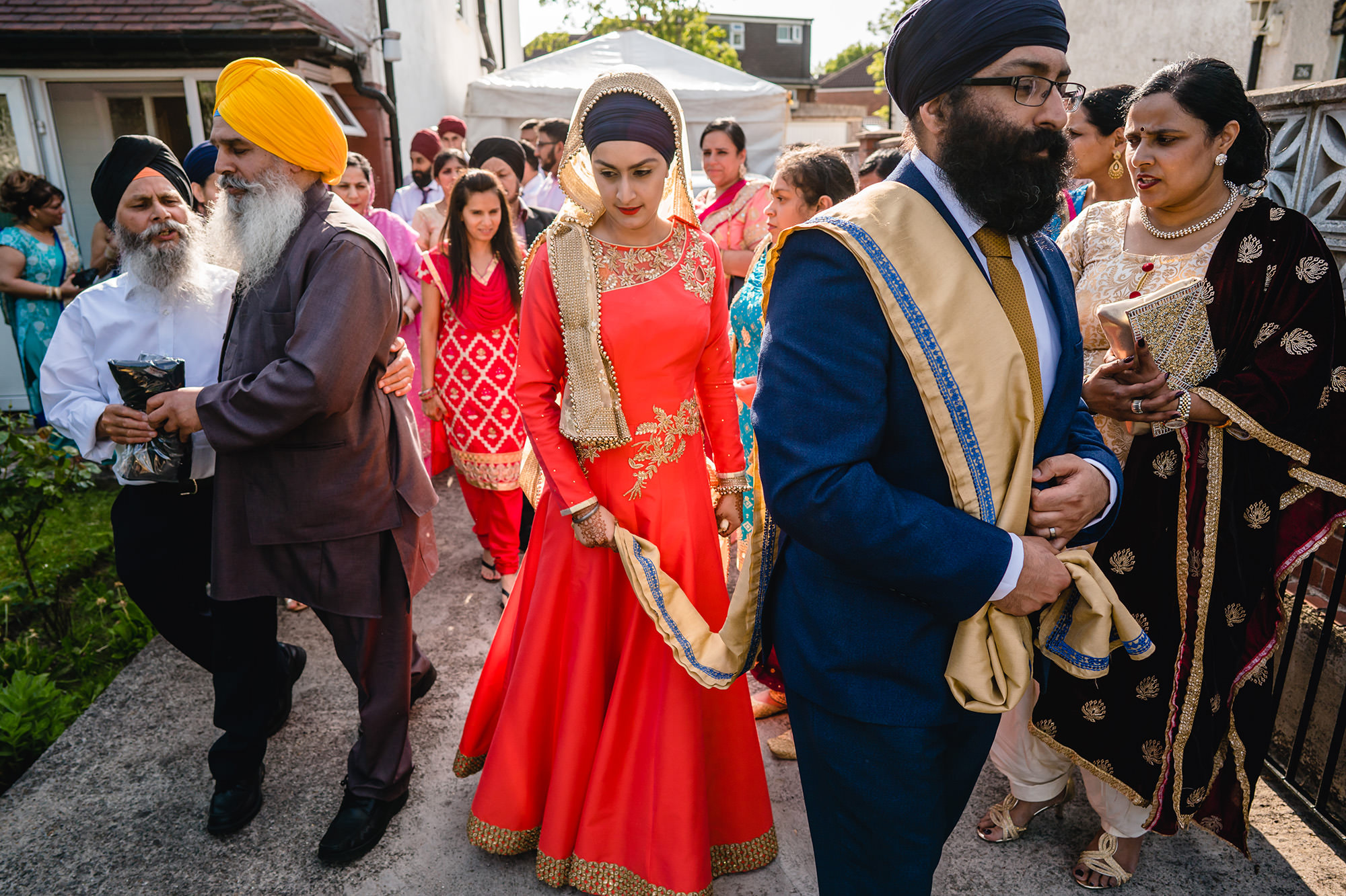 bride and groom leaving brides house after sikh wedding ceremony