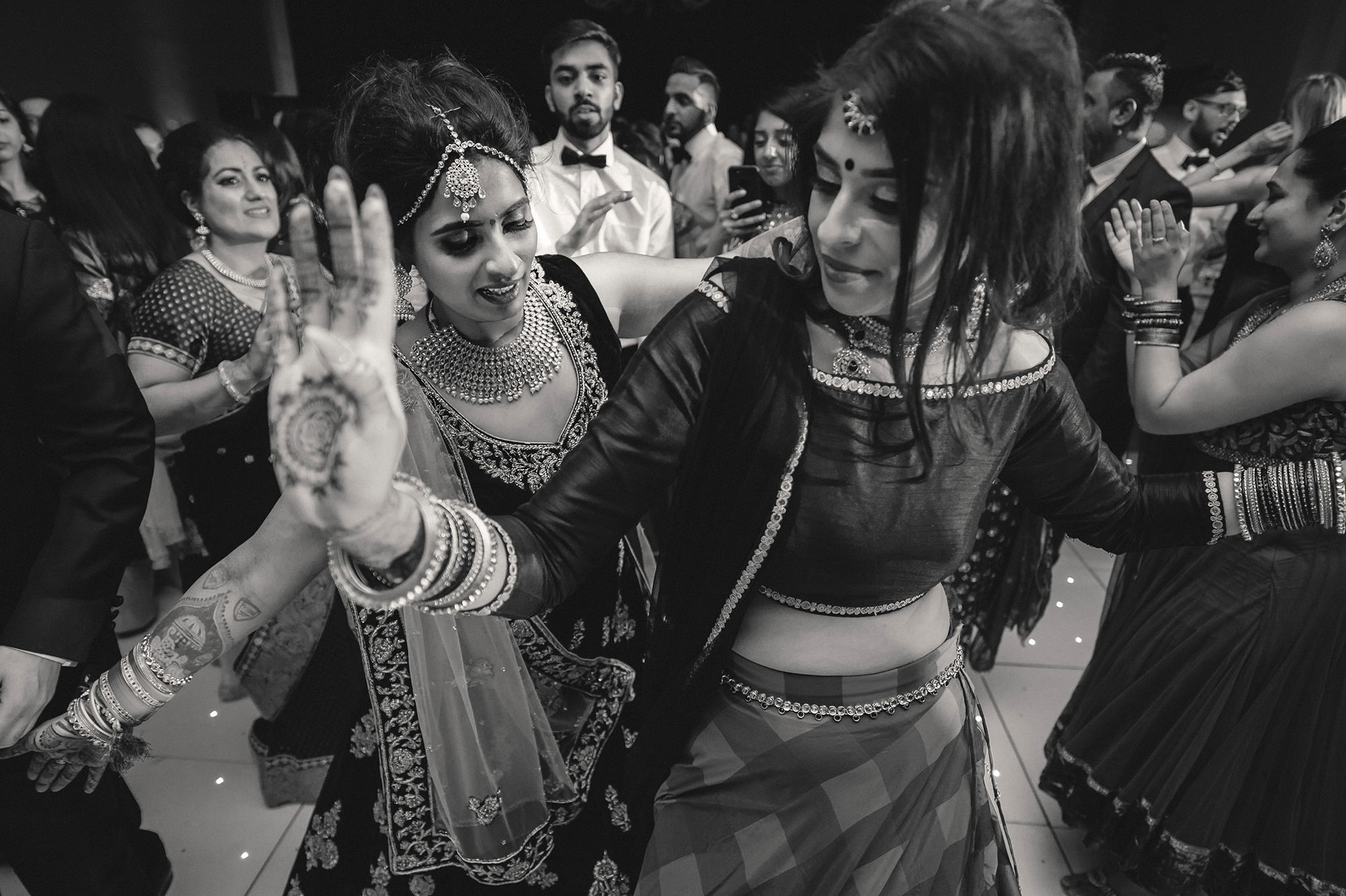 black and white of sisters dancing on the dancefloor