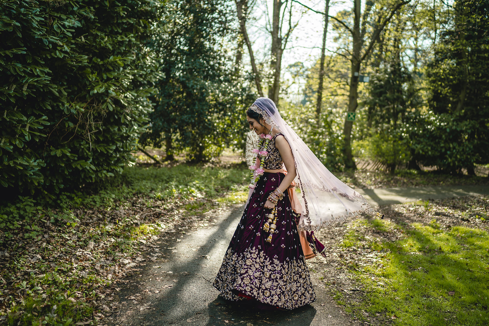 bride spinning at the belfry in her indian wedding outfit